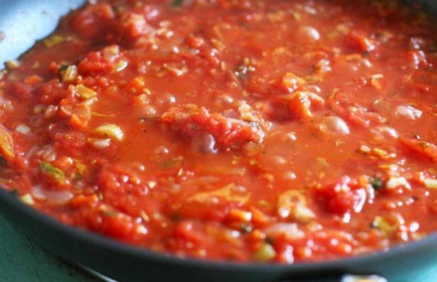 This recipe creates a hearty tomato sauce made with tomatoes, sauteed onions, garlic and parsley.
