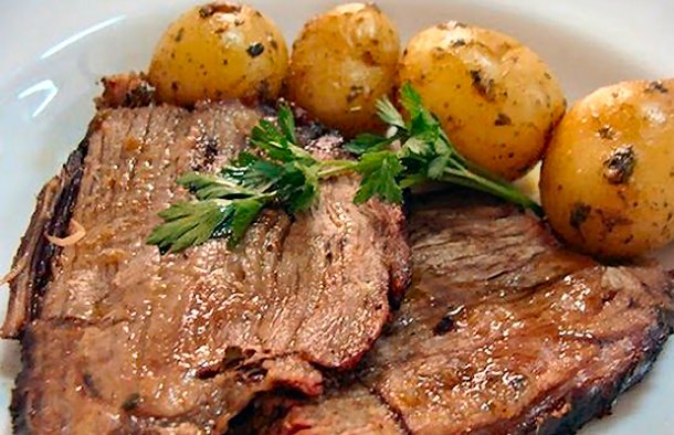 This Portuguese pot roast (carne assada) recipe, makes a sumptuous feast of beef with roast potatoes.